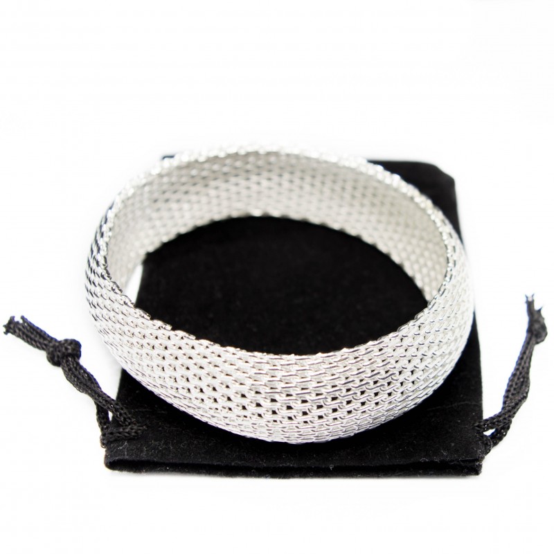 Bracelet large en argent pour femme avec une texture en maille.